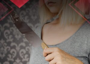 Woman holding a knife with a person face reflected on it